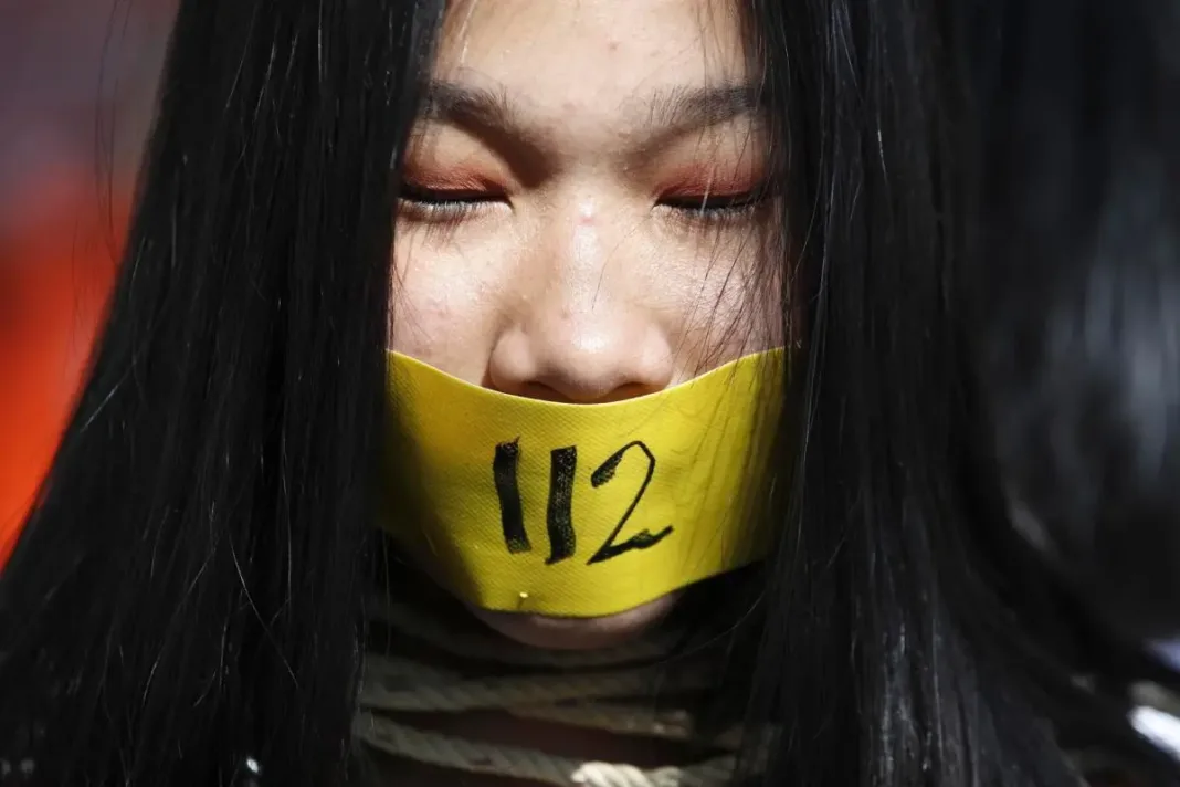 An anti-government protester covers her mouth during a rally